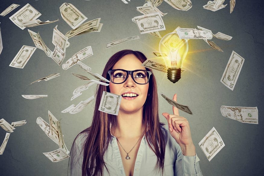 A young woman wearing glasses looking up at a glowing light bulb with an idea signified by illumination, as dollar bills float around her, suggesting a concept of financial inspiration or monetary gain from ideas.