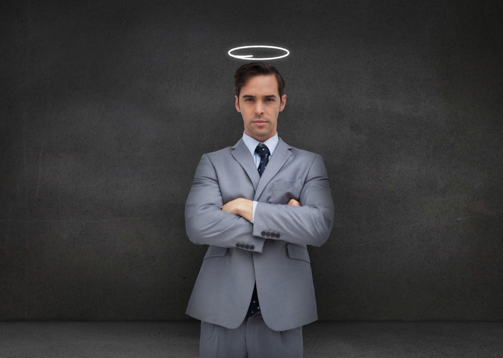 Grey suit man with halo conveys authority and virtue against dark backdrop.