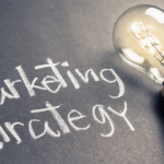 Bright Marketing Ideas Sparked by Light Bulb on Chalkboard.
