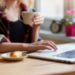 Cozy Home Workspace with Laptop, Tea, and Pastry for Productivity and Relaxation.