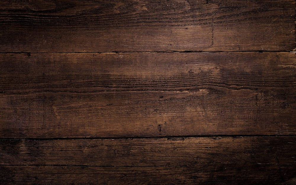 Dark brown wooden planks with a rough texture aligned horizontally.