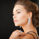 Elegant woman with sparkling chandelier earrings in serene profile.