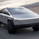 Futuristic electric pickup truck driving on open road with sleek design and modern features.