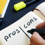 Person creating pros and cons list in notebook with marker and highlighter on desk.