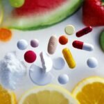 Fresh fruits vs pharmaceutical pills: a vivid health choice on a white surface.