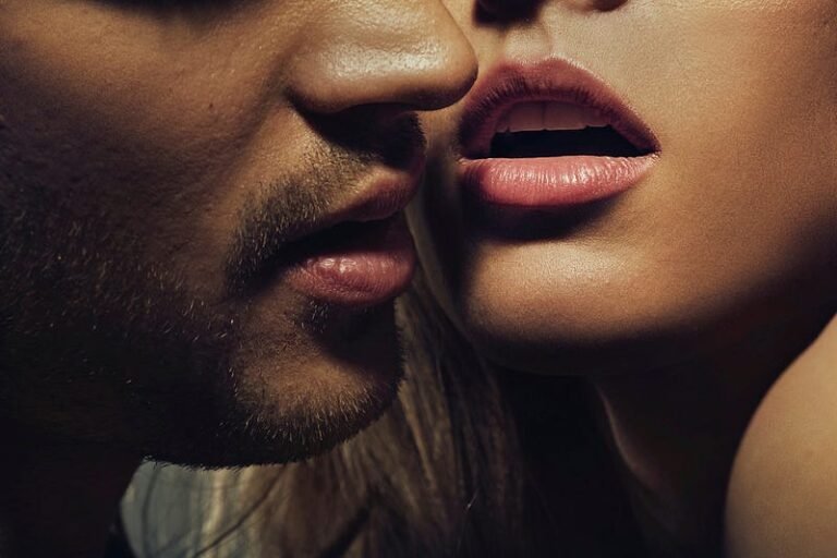 Man and woman in intimate moment about to kiss, creating tension and anticipation.