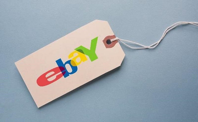 Beige eBay logo price tag on blue background for online sales and commerce.