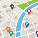 City map with colorful landmark pins and river view for urban navigation.