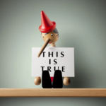 Whimsical Pinocchio Holding THIS IS TRUE Sign on Wooden Shelf