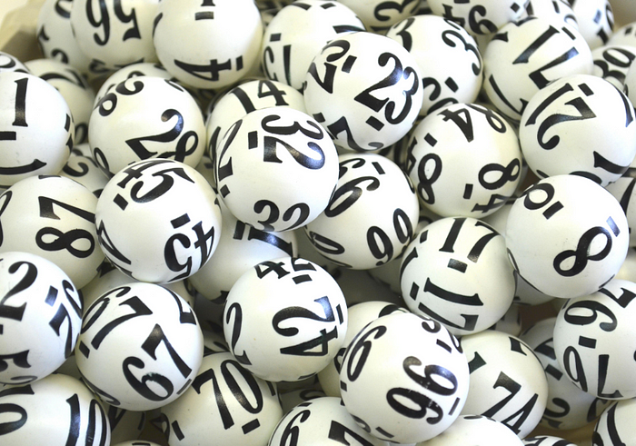 Close-Up of White Lottery Balls - Numbers in Bold Black for Luck & Chance