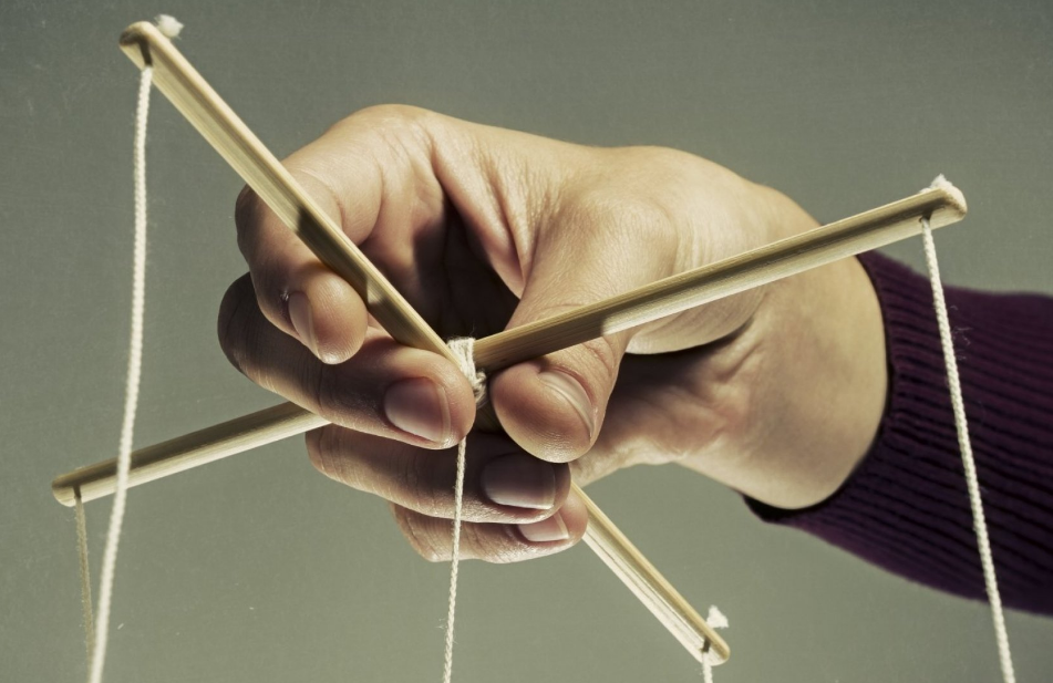 Close-up of a person's hands manipulating a Jacob's ladder toy made of wooden blocks and strings.