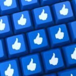 Approval-themed keyboard keys with white thumbs-up icons on a blue background.