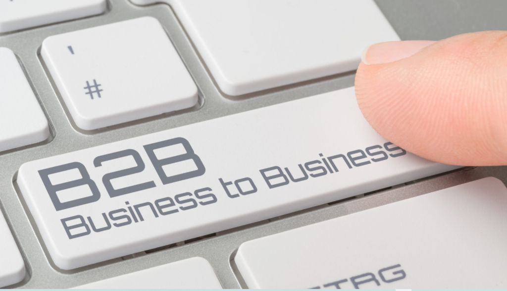 A finger pressing a keyboard button with the label "B2B Business to Business."