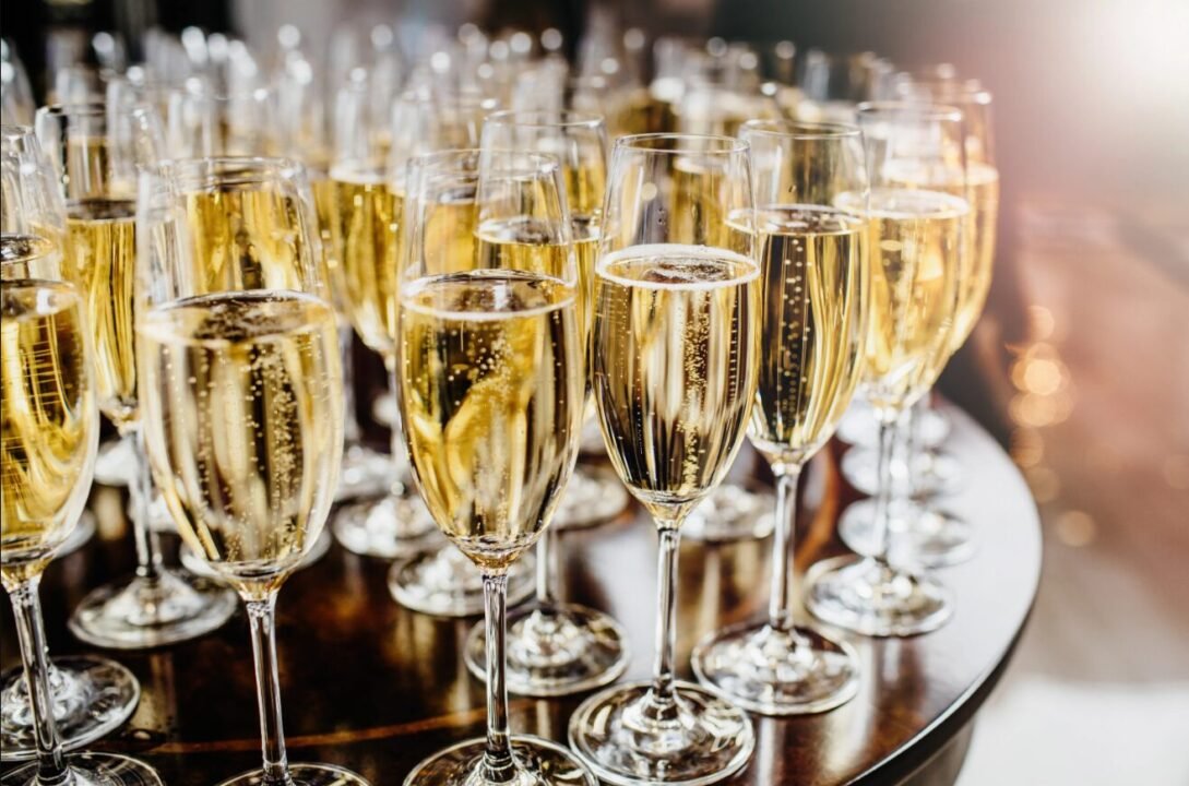 Elegant champagne flutes ready for celebration at festive event.