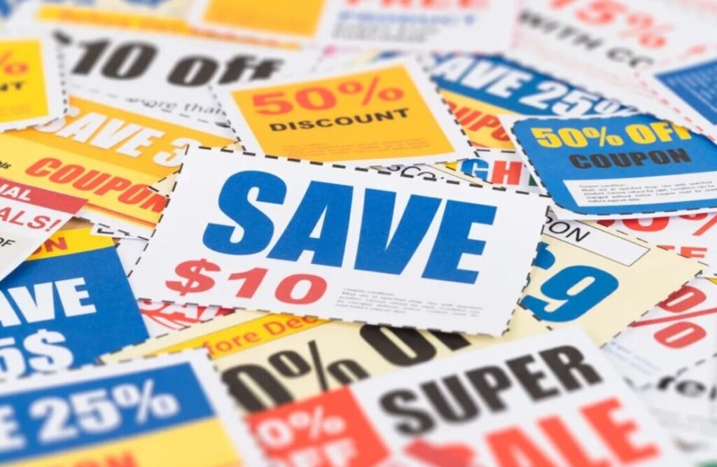 Assortment of colorful discount coupons scattered on a surface, featuring savings like "SAVE $10" and "50% OFF".