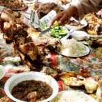 Cultural communal dining with Middle-Eastern cuisine, featuring shared meal on colorful cloth.