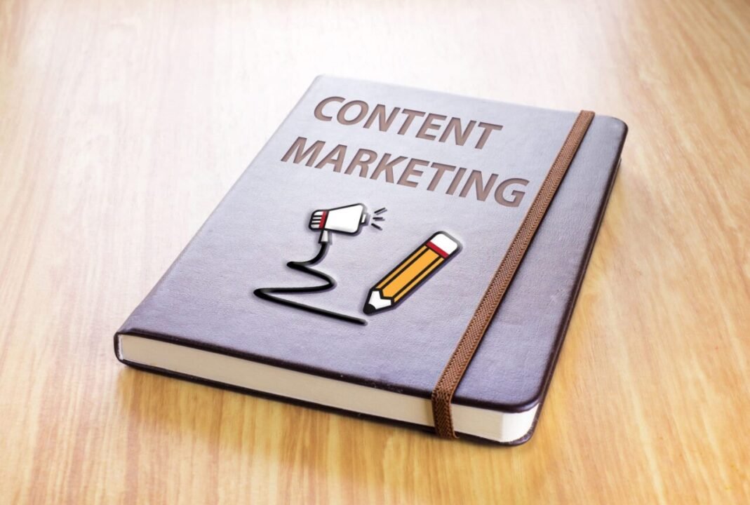 Content Marketing Book with Megaphone and Pencil Illustration on Wooden Surface