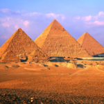 Sunset view of iconic Egyptian Pyramids in Giza, showcasing ancient engineering and civilization.