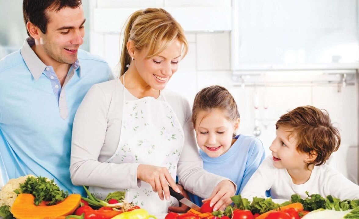 Family cooking together in a cheerful kitchen scene with fresh vegetables, warm atmosphere.