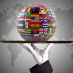 Global unity symbolized by person holding globe with national flags, emphasizing diplomacy & service.