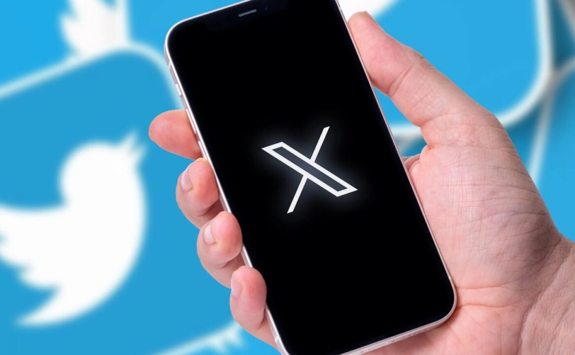 Smartphone displaying white X symbol against Twitter background, hinting at possible disruption.