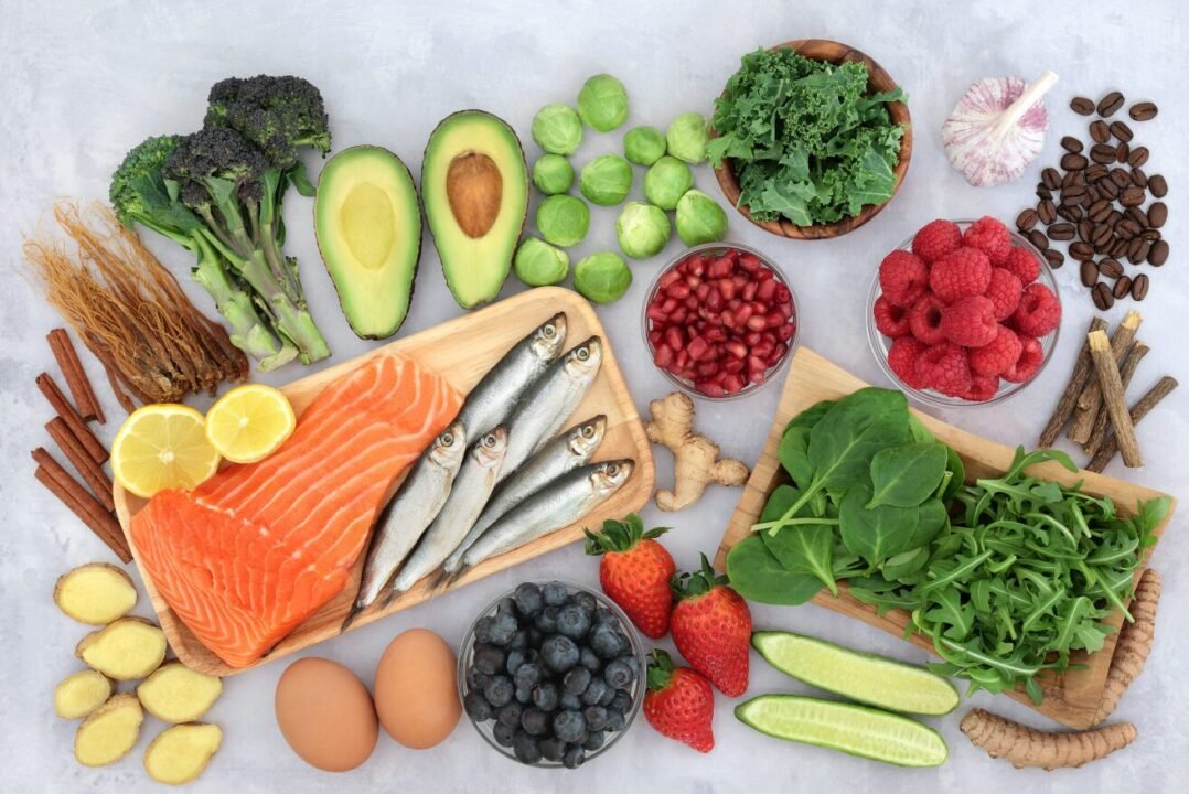 Assorted healthy foods display vibrant colors and nutrients on light background.