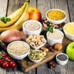 Assorted healthy foods on wooden surface promoting balanced and nutritious diet.