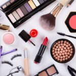 Assorted makeup essentials on white background for beauty routine.