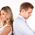 Tense standoff between serious man and woman on white background.