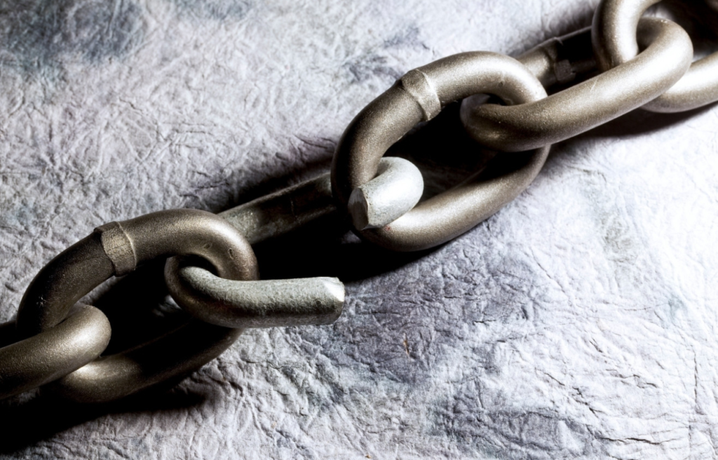 A close-up of a strong metal chain with interlocked links on a textured background.