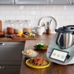 Sophisticated kitchen appliance with digital display, surrounded by prepared dishes and ingredients.