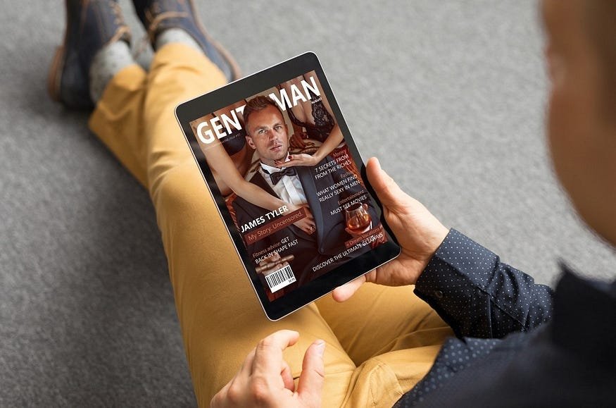 A man is sitting and reading magazine