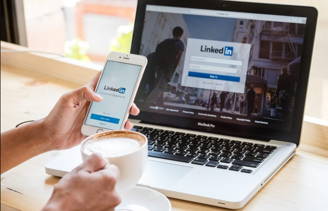 Networking on LinkedIn during coffee break at work - modern professional multitasking.