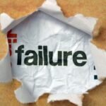 Discovering success amidst failure through torn paper with bold black and red lettering.