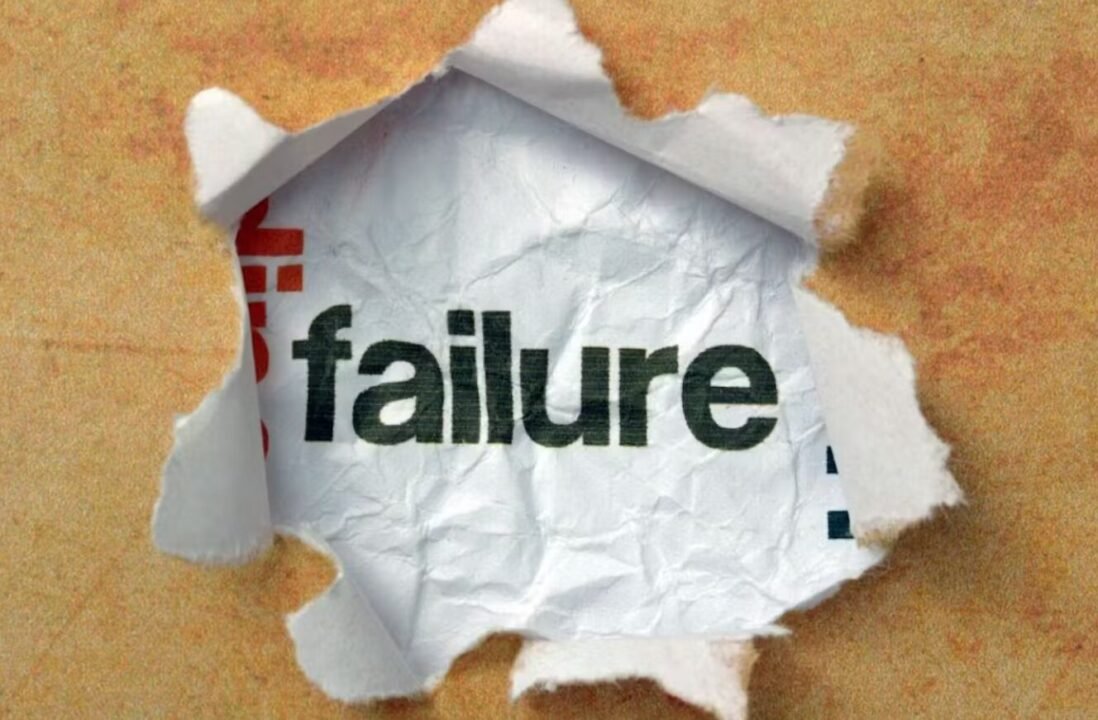 Discovering success amidst failure through torn paper with bold black and red lettering.