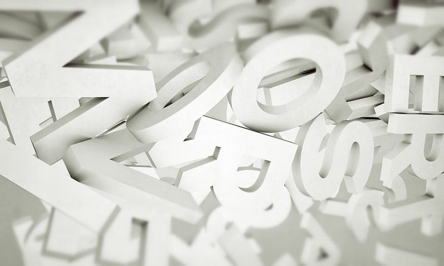Diverse white 3D letters scattered on surface, highlighted by soft light.