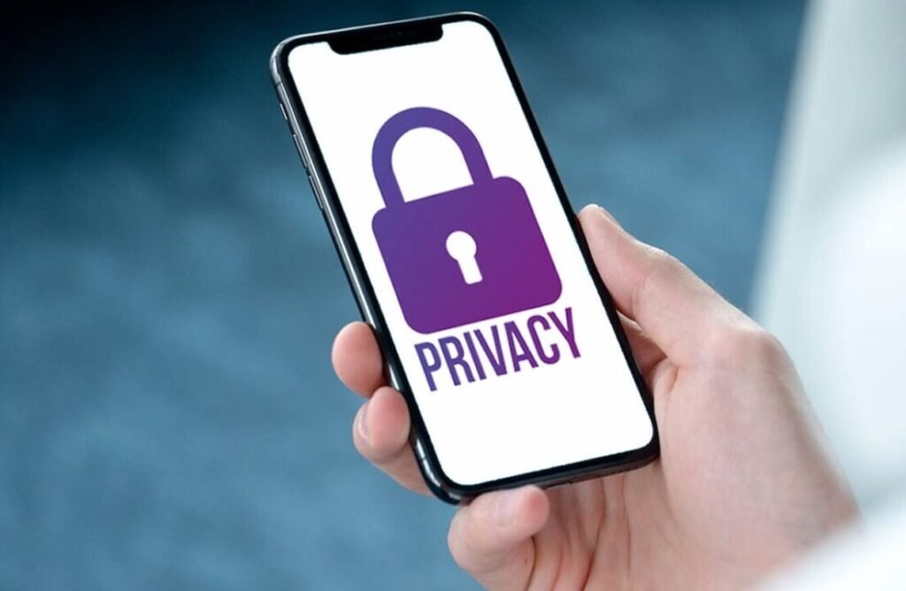 Person holding a smartphone displaying a privacy lock icon with the word "PRIVACY" on the screen.