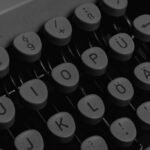 Vintage typewriter keys in black and white, showcasing tactile and mechanical essence of traditional typing.