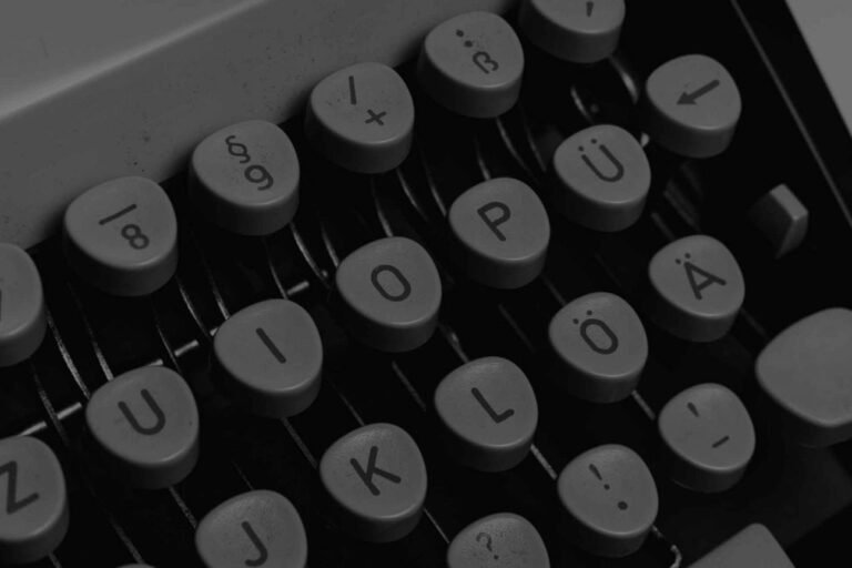 Vintage typewriter keys in black and white, showcasing tactile and mechanical essence of traditional typing.