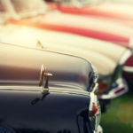 Vintage cars gleam in sunlight, showcasing classic charm and meticulous maintenance for enthusiasts.