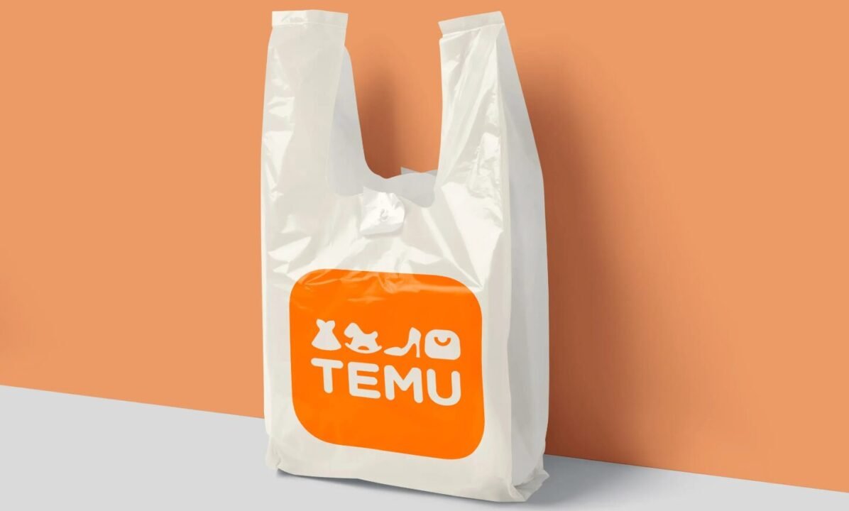 White plastic shopping bag with orange TEMU logo on peach and gray background.