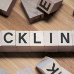 Wooden blocks spell BACKLINKS on table, visually illustrating SEO backlinks concept.