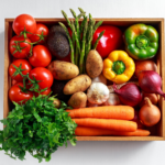 Vibrant assortment of fresh vegetables in wooden crate: carrots, parsley, tomatoes, potatoes, onions.