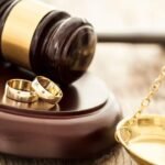 Legal decision: wedding rings, gavel, scales - symbolizing marriage or divorce proceedings in court.