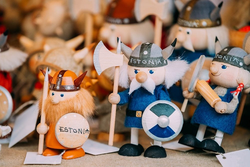 Hand-painted Viking figurines from Estonia with helmets, shields, and weapons in a collection.