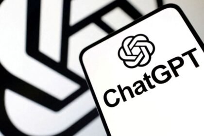 Close-up of a ChatGPT logo on a card with a blurred black and white geometric background.