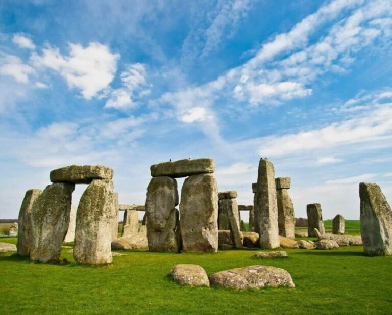 Stonehenge monument in Wiltshire, England, under clear blue sky with ancient standing stones.