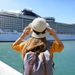 Tranquil moment: Woman admiring cruise ship on sunny dock.