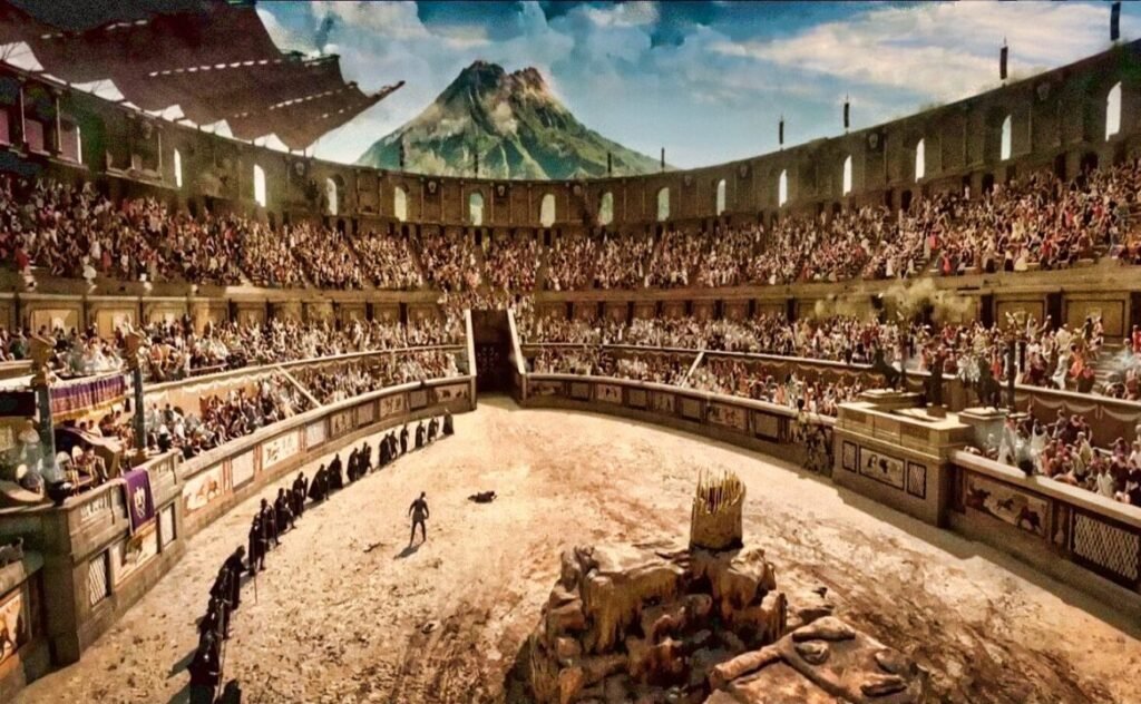 A digital depiction of an ancient Roman gladiatorial arena filled with spectators, featuring a single gladiator in the center and a volcano in the background.