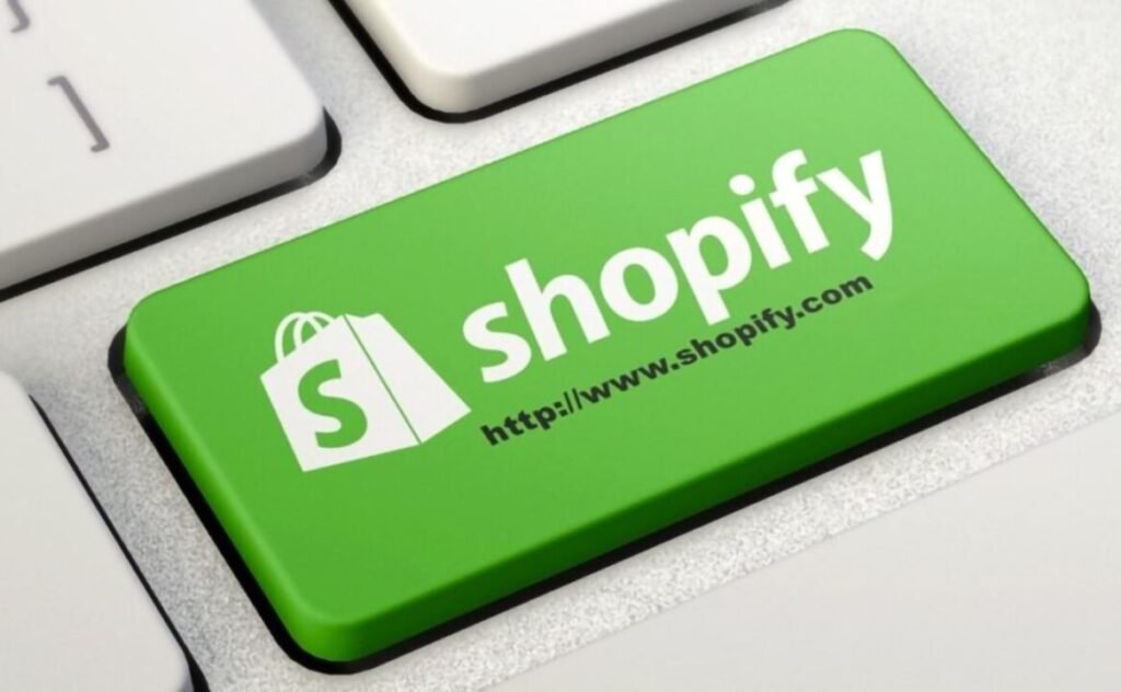 A close-up of a green Shopify-branded key on a white keyboard.